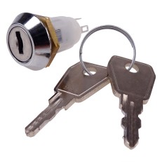 Detaljvy av reservlås för kopplingslåda – cylindrisk form i silver och guld med nyckelhål och två nycklar.