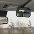 Frontvy av backspegel med sugkopp och klämma – oval form i svart och grått, placerad i bilens inredning.