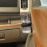 Set of 2 cup holders for the car – side view showing black strap and brown drink holder mounted on dashboard.