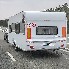 Caravan – back view featuring an 80 speed sticker in white and red against a road background.