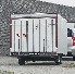 Speed sticker "80" – back view on a trailer with a white and red design against a concrete background.