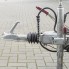 Trailer cable spring – side view showing grey rubber bellows and handbrake lever in down position on a concrete background.